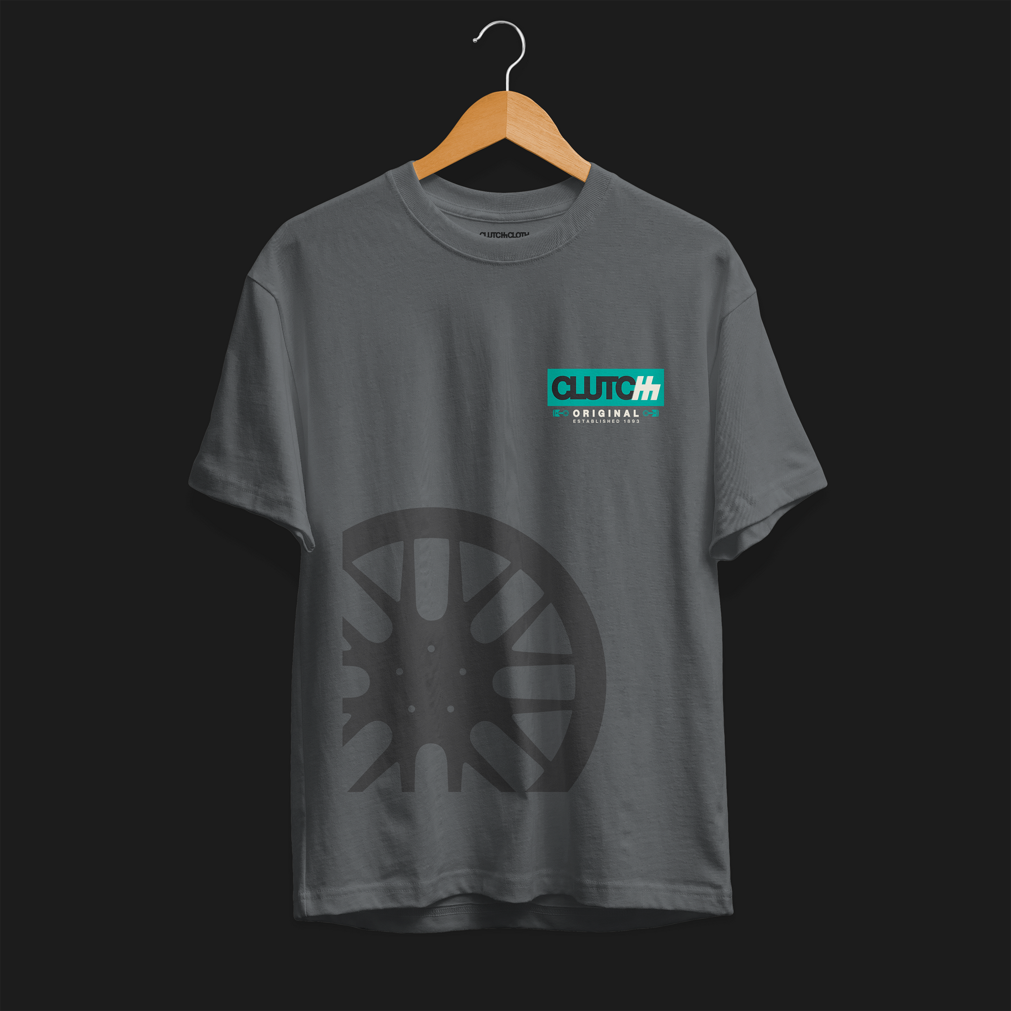 Clutch Original Est 1983 Automotive Graphic T-Shirt – charcoal tee with Clutch Original logo on the chest and a subtle wheel graphic. Perfect for car enthusiasts and motorsport fans.