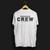 Paddock Crew Automotive T-Shirt – Back view of white Paddock Crew graphic tee featuring bold "Paddock Crew" text and "Gear Up, Rev High" tagline. Perfect gift for motorsport and car culture enthusiasts.