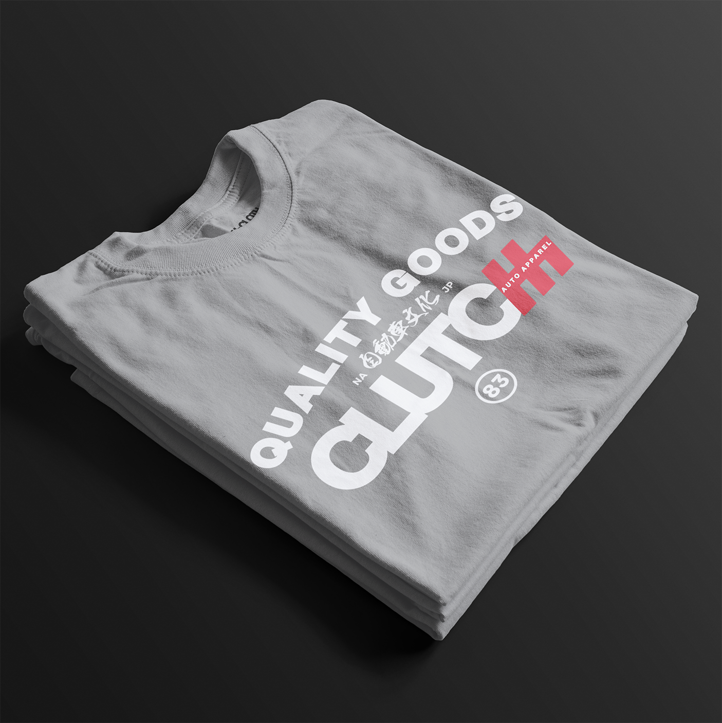 Quality Goods Car Culture 83 Automotive Graphic T-Shirt – folded sport grey tee with "Quality Goods" and "Clutch Auto Apparel" text, accented with Japanese characters and red highlights. Perfect gift for car enthusiasts and streetwear fans.