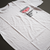 ClutchCloth Racing Signature Series No.1 Automotive Graphic T-Shirt – White tee featuring a side-profile racing car design with red and black geometric accents. Ideal gift for motorsport enthusiasts and car culture fans.