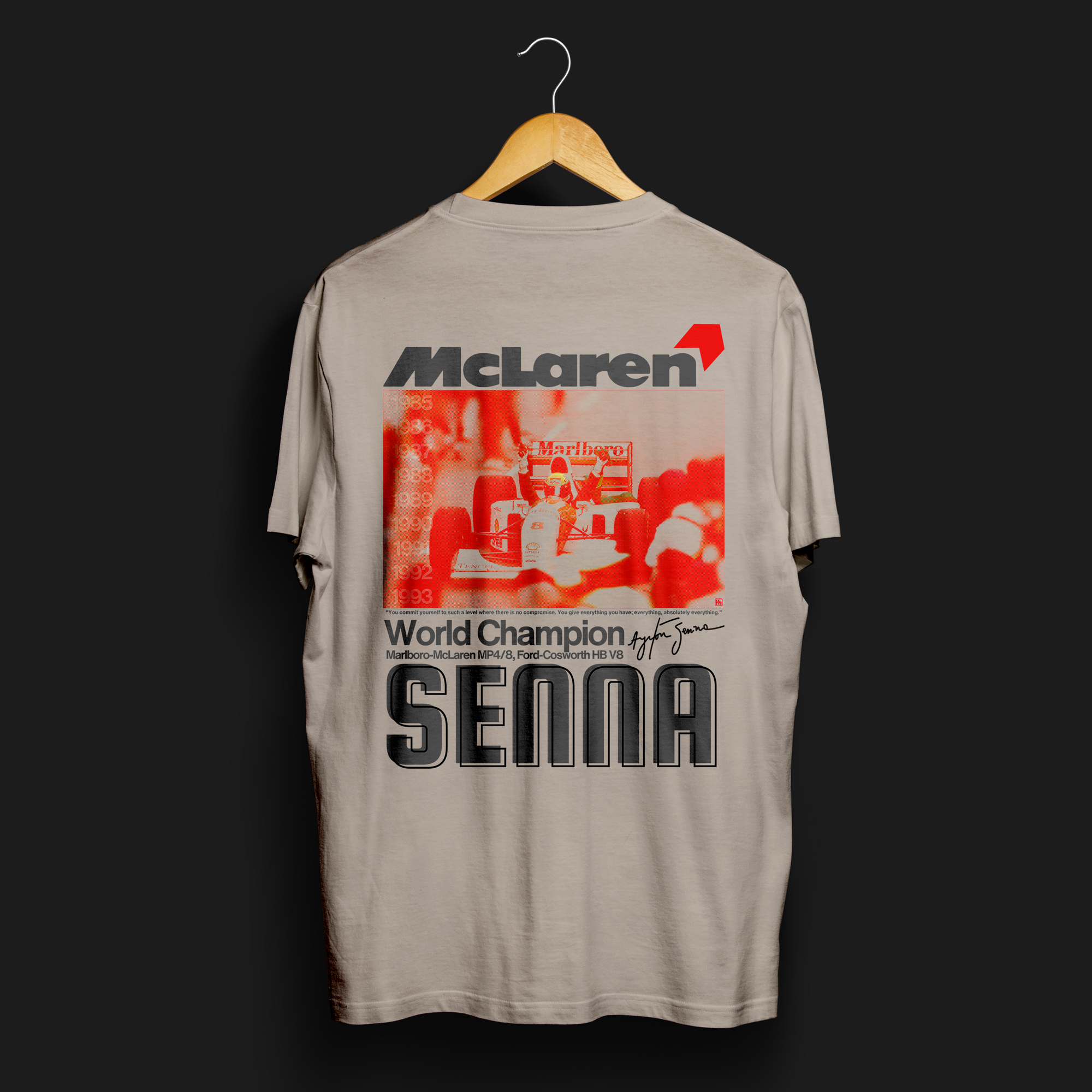 Senna - Give Everything Automotive Graphic T-Shirt – tee featuring an iconic Ayrton Senna McLaren design with bold red and black text. Perfect for F1 fans and motorsport enthusiasts.